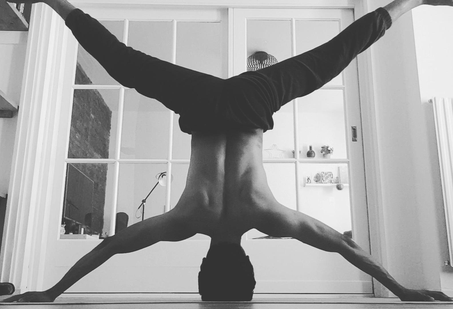 Farooq demonstrating a controlled straddle headstand during his personal yoga practice